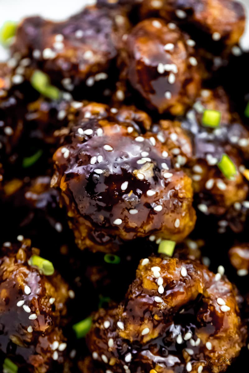 Close up of cauliflower wings, covered in sesame seeds. 