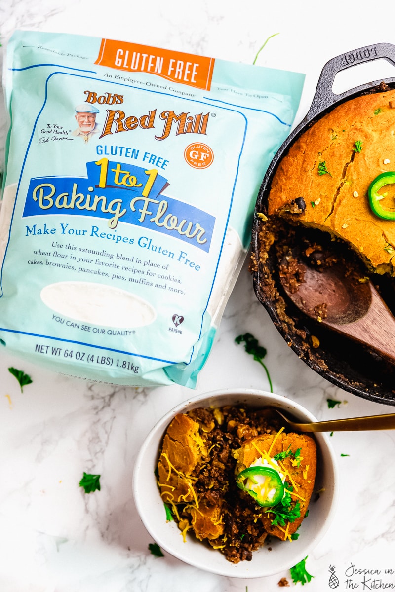 A pack of baking flour next to a bowl of cornbread casserole. 