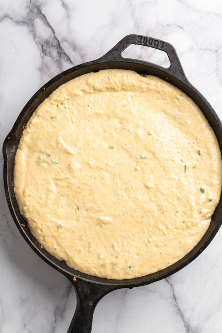 This vegan chili cornbread casserole is one of the BEST casseroles ever! The secret? Sweet, crispy cornbread baked on top of delicious chili. Cornbread topping added to skillet of chili