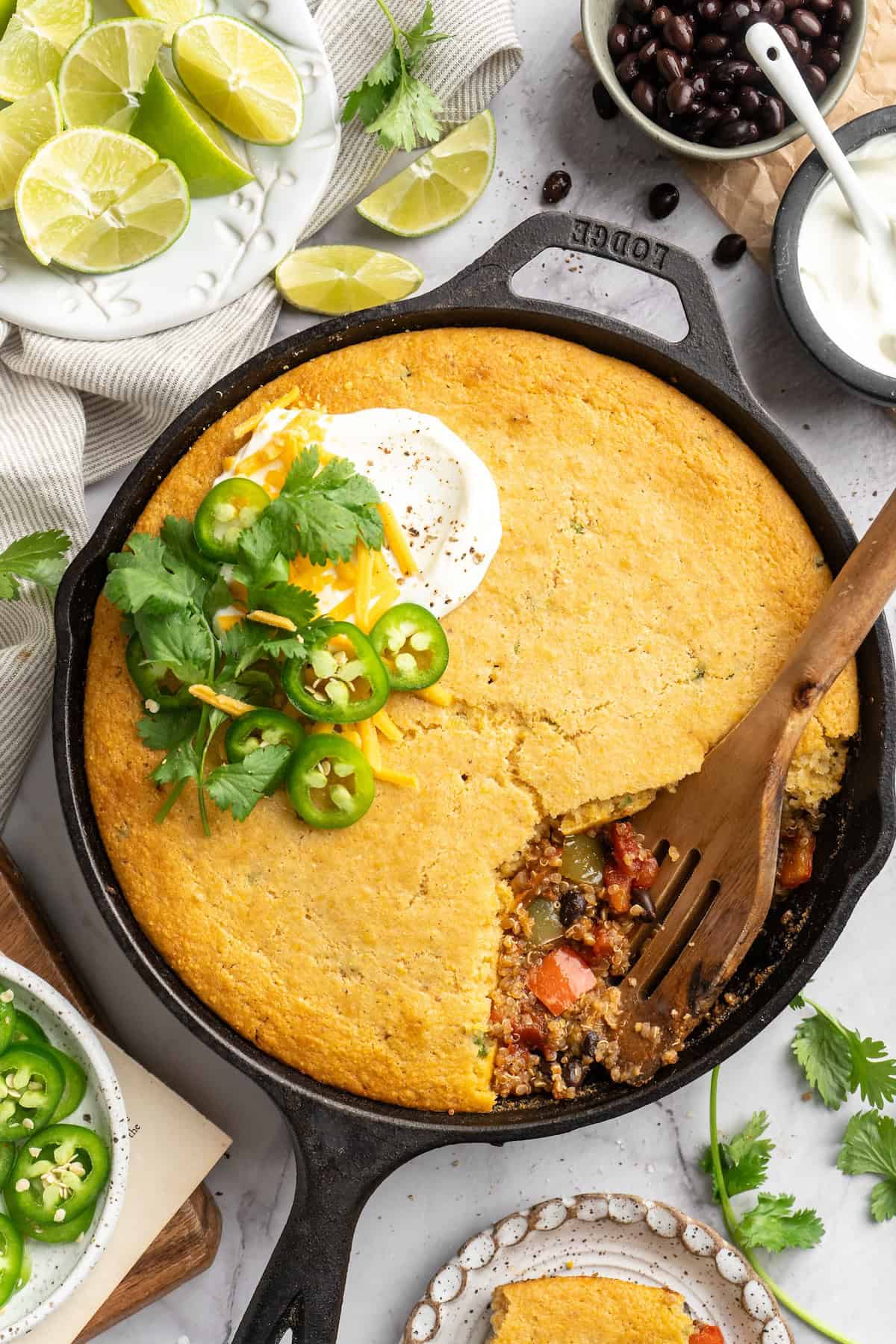 This vegan chili cornbread casserole is one of the BEST casseroles ever! The secret? Sweet, crispy cornbread baked on top of delicious chili. Overhead view of chili cornbread casserole in skillet