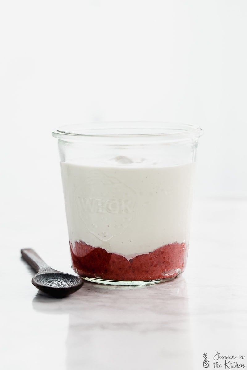 Side shot of vegan yogurt in a glass.