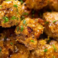 Closeup of lemon pepper cauliflower wings on a plate.