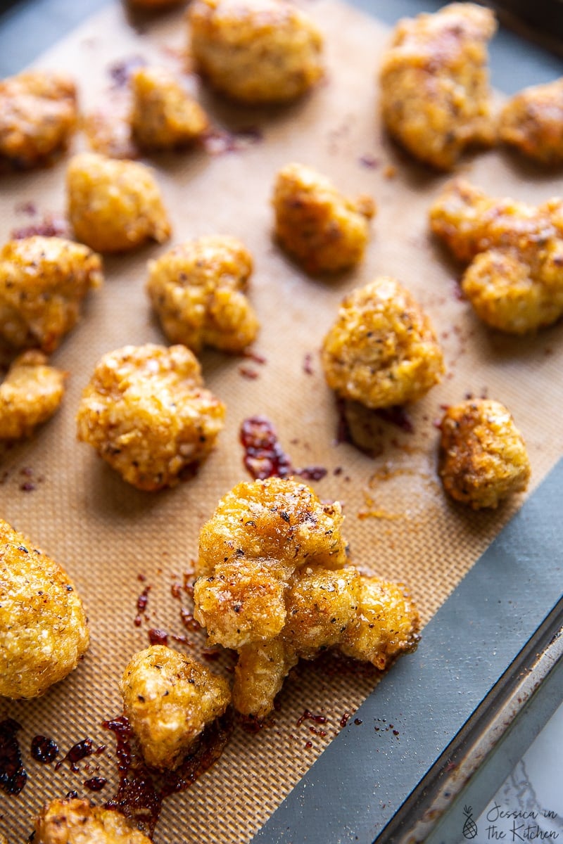 Lemon pepper cauliflower wings on a baking sheet. 