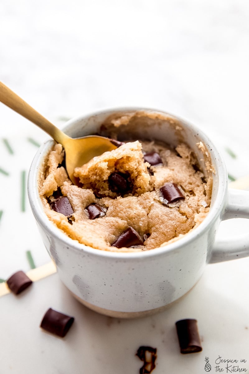 A spoon scooping into a chocolate chip tahini mug cake. 