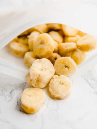 Frozen banana slices coming out of a ziplock bag.