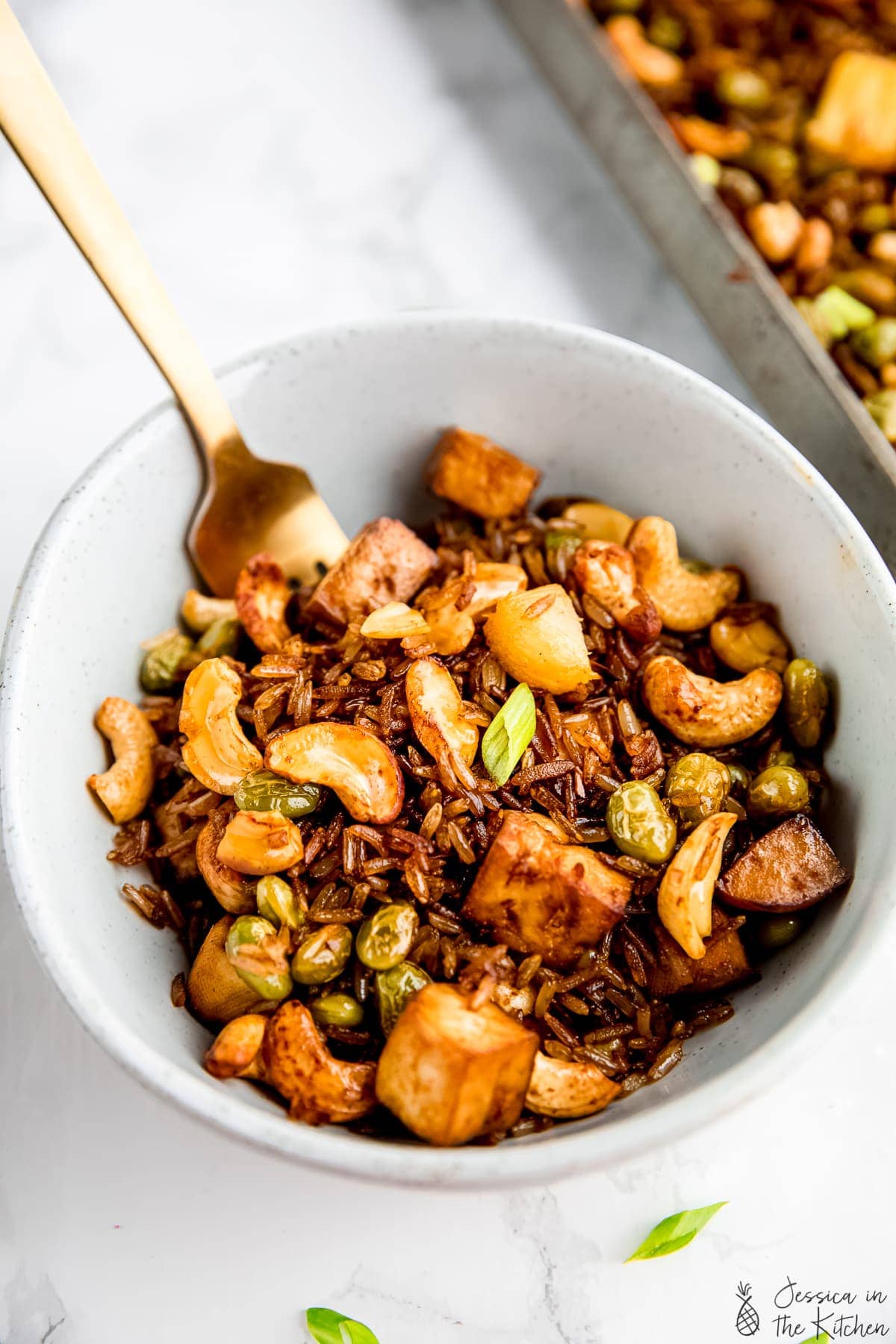 Bowl of vegan fried rice with tofu and cashews