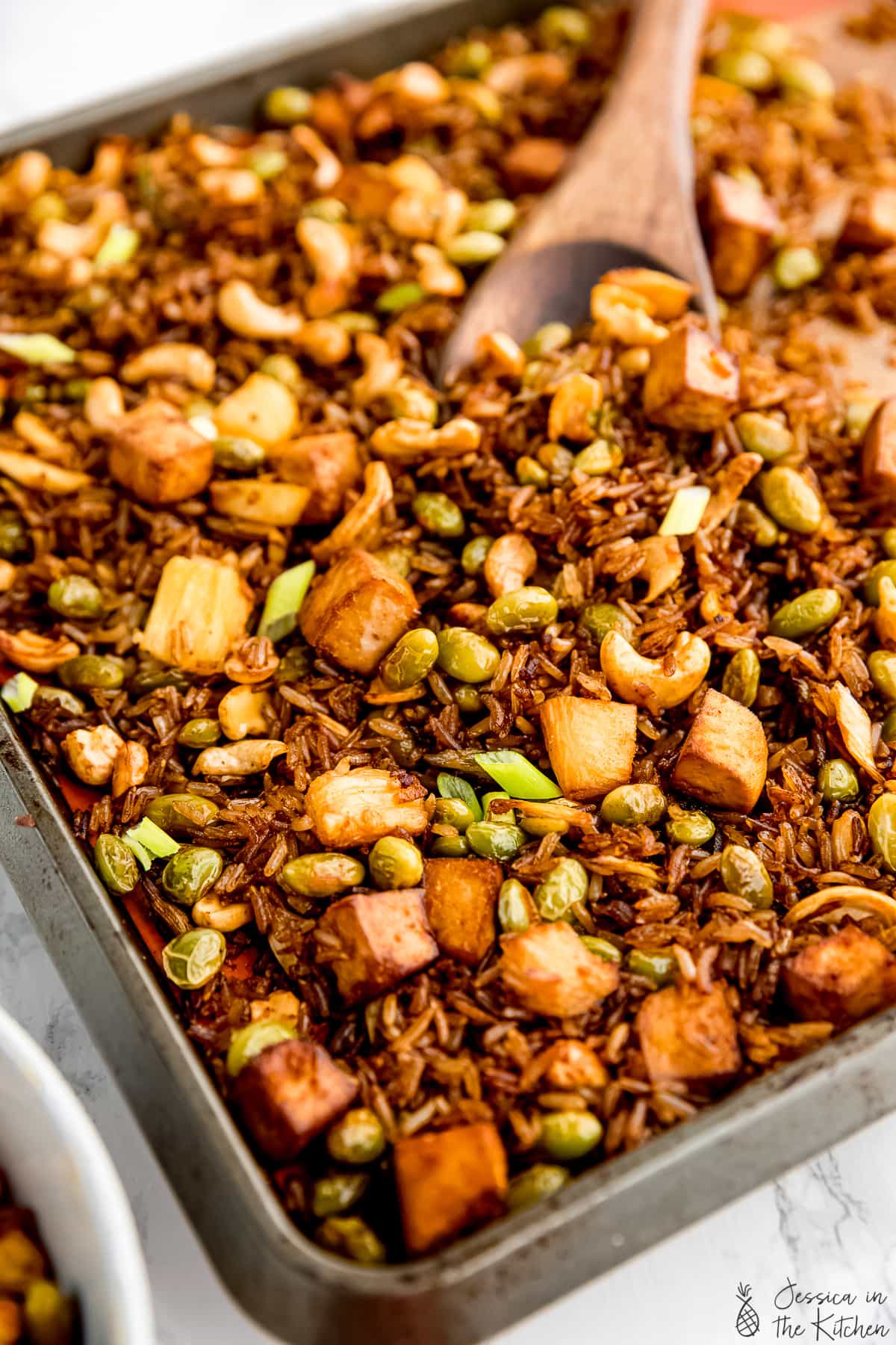 Sheet pan of vegan fried rice with tofu, pineapple, and cashews