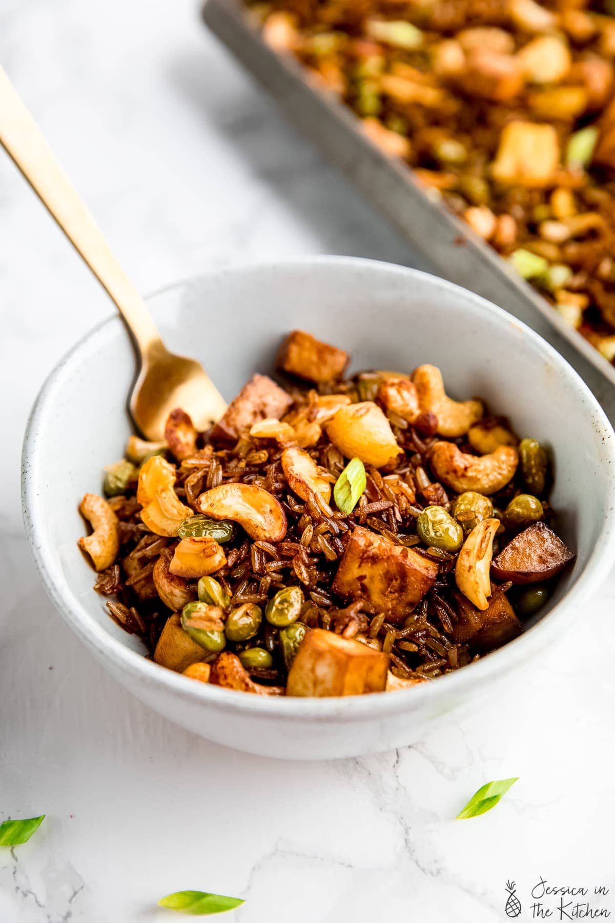 Bowl of crispy vegan fried rice with tofu and cashews