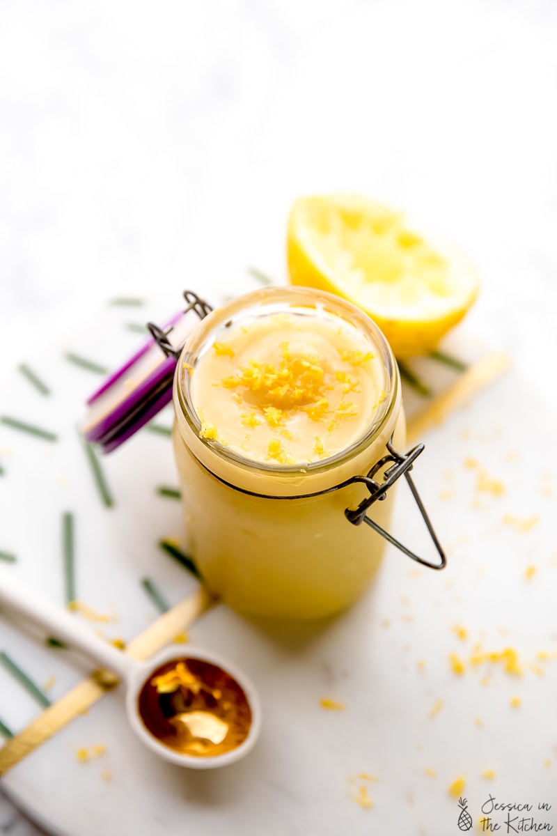 Vegan lemon curd in jar with lemon zest.