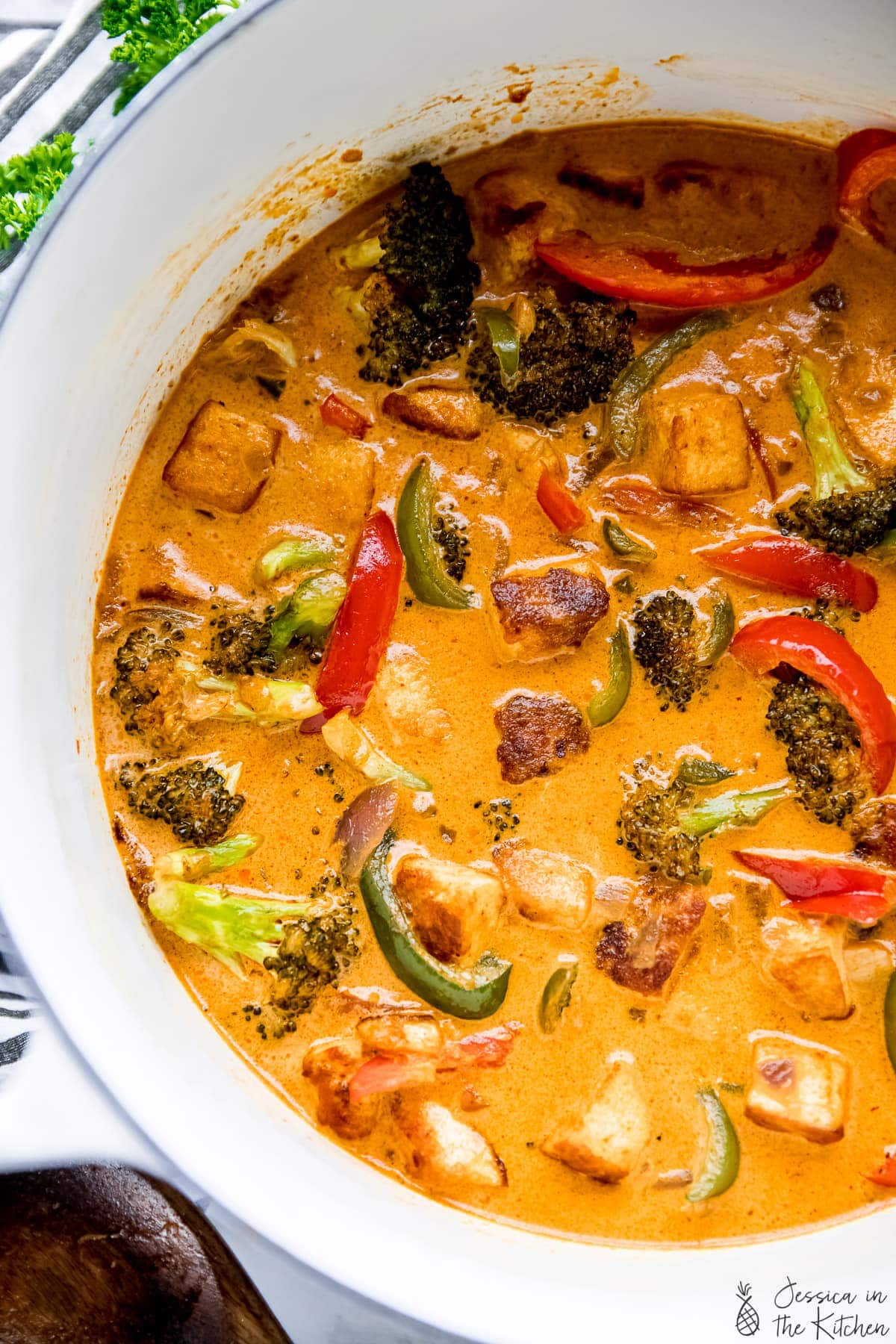 Overhead view of vegan Thai red curry in white Dutch oven