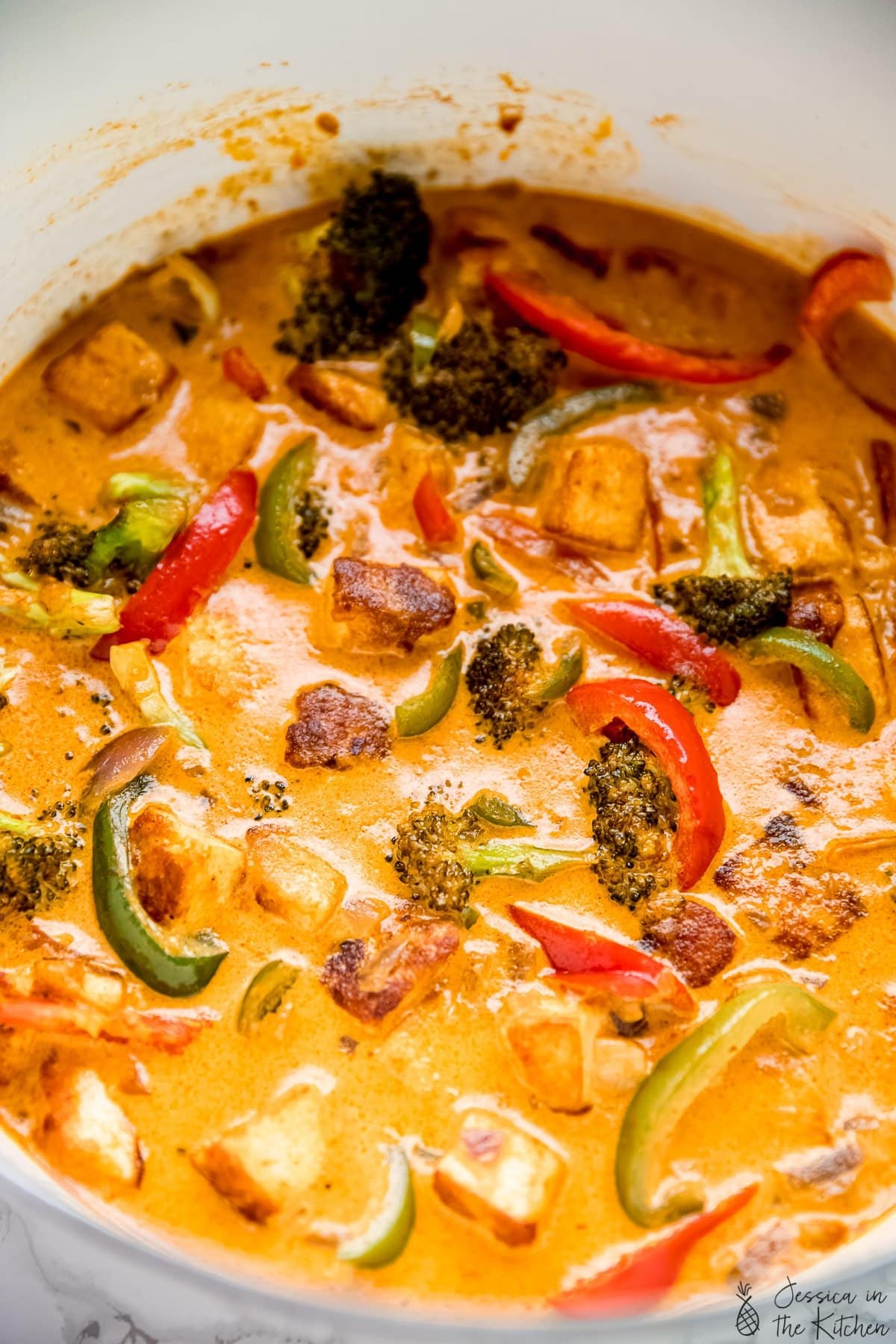 Vegan thai red curry in stock pot, overhead photo.