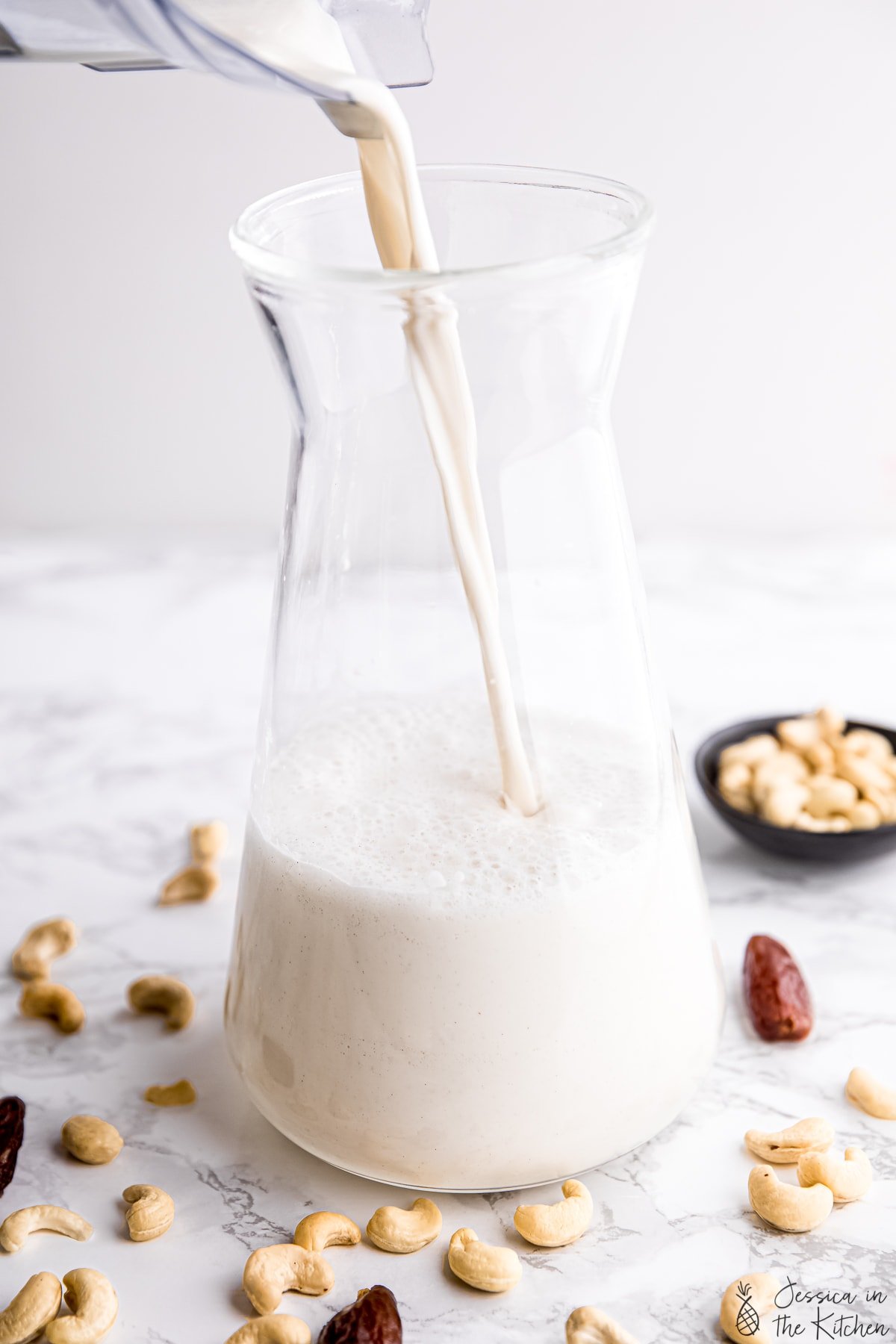 Cashew milk being poured into a container.