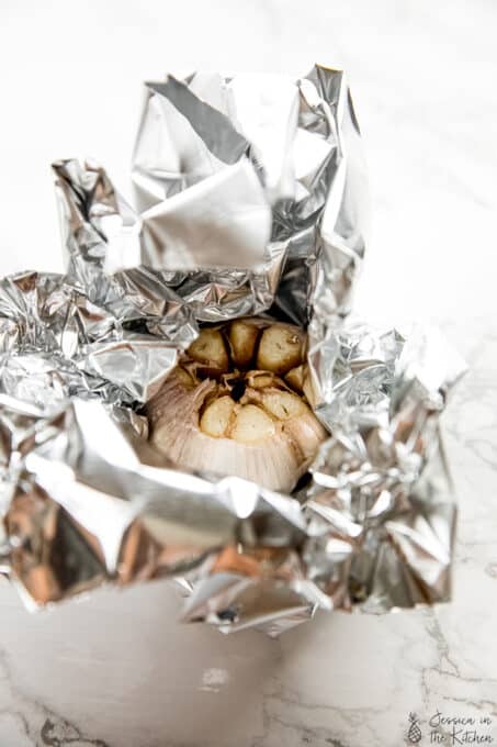 Wrapping garlic head with foil