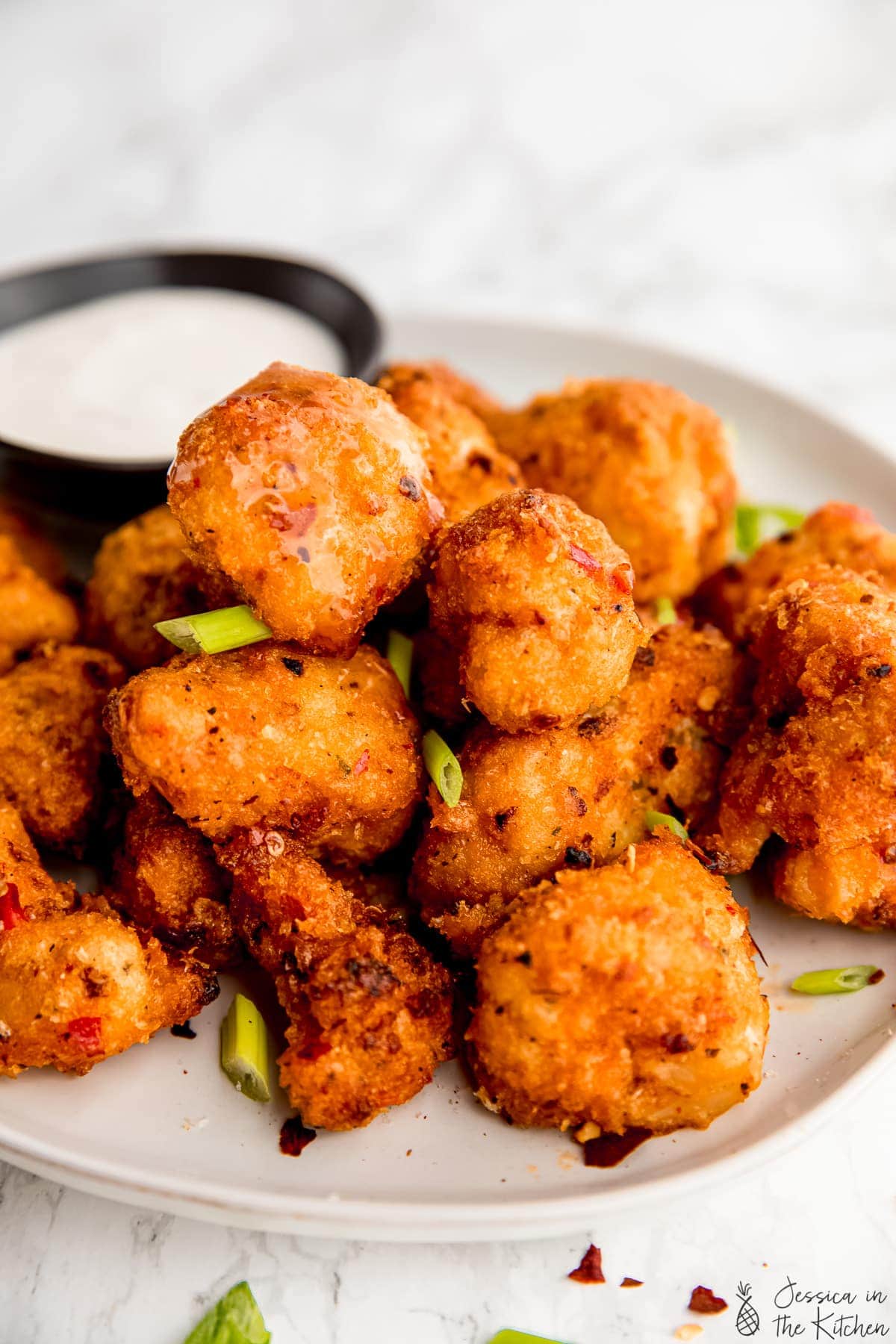 Close up of bang bang cauliflower wings on a plate.