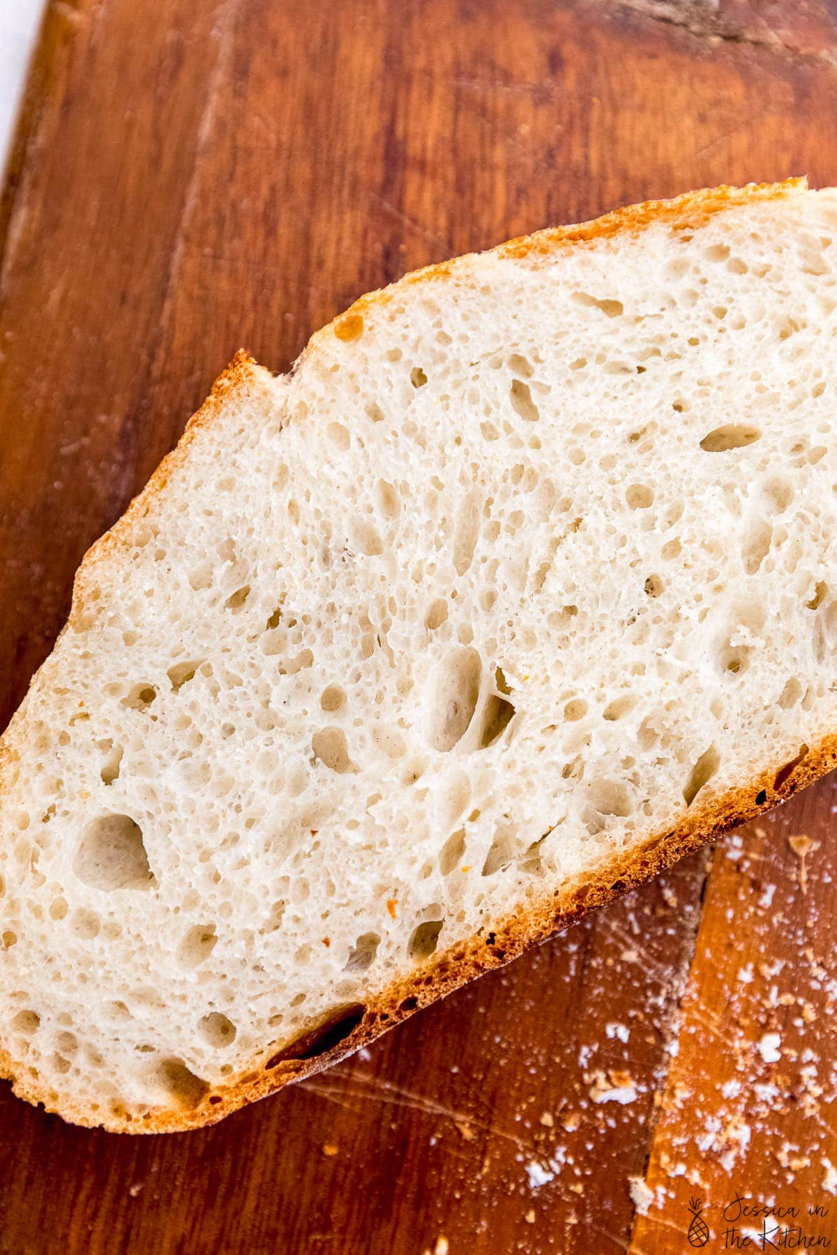 Single slice of bread birds eye view on a cutting board.