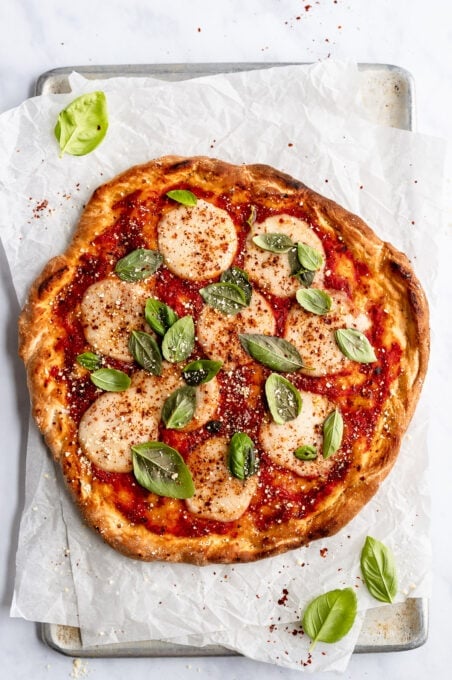 photo of finished vegan pizza topped with mozzarella and basil