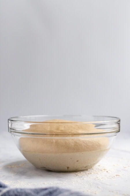dough in a bowl that has been risen at a side angle