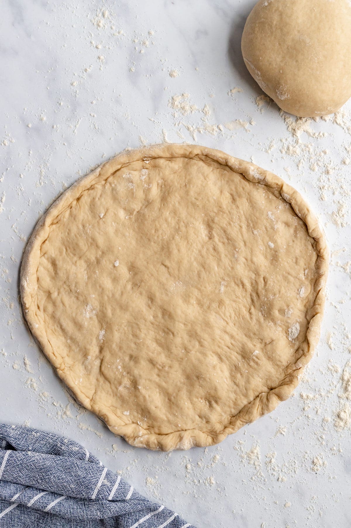 Rolled out pizza dough into a crust shape.