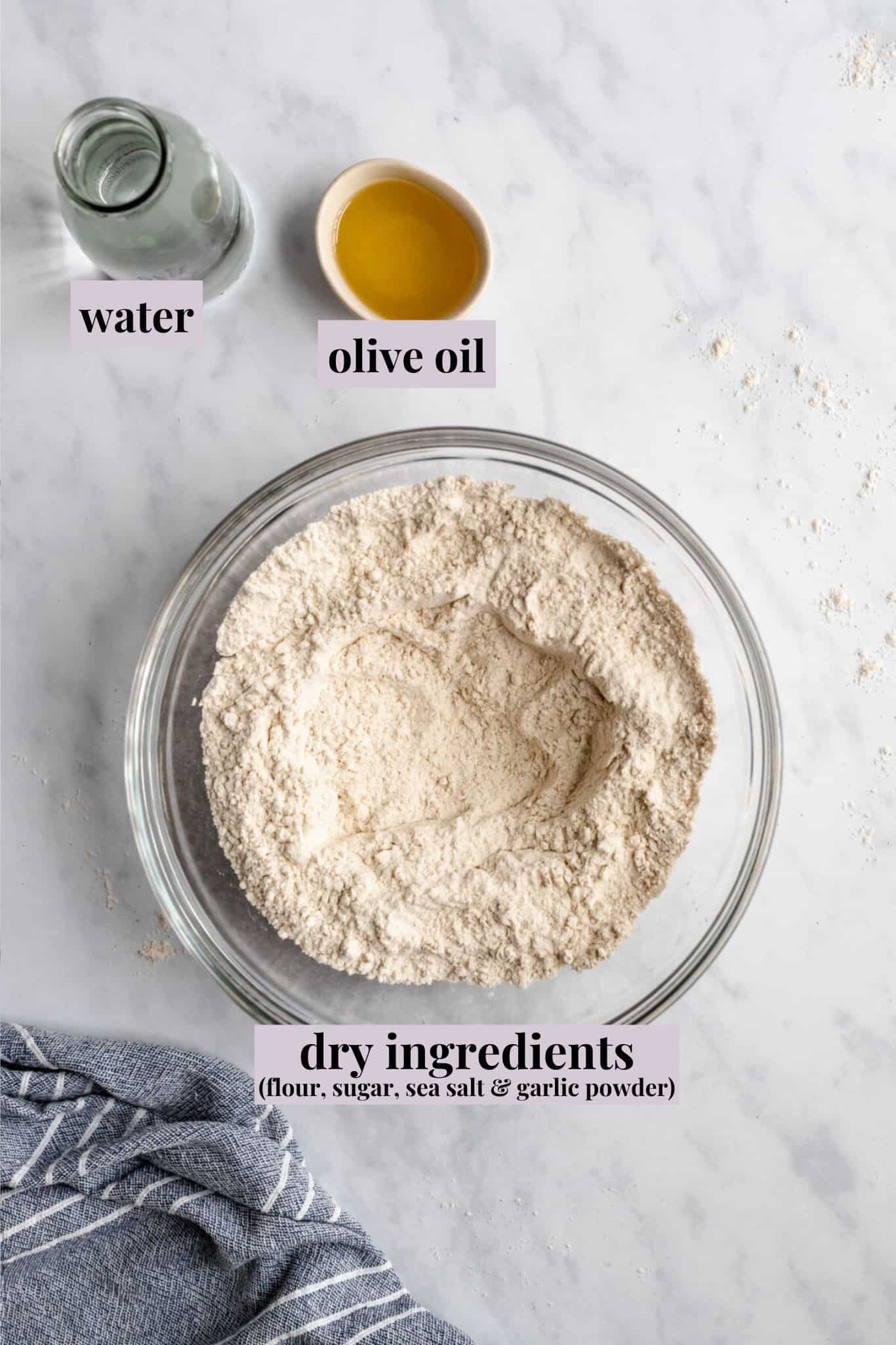 Ingredients for vegan pizza dough on a marble counter.