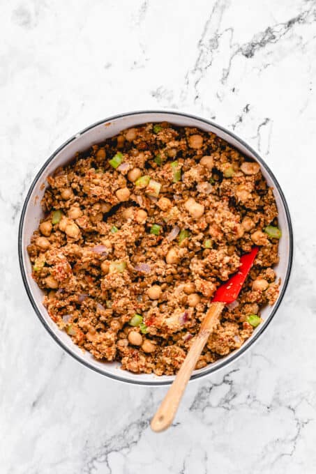 Vegan meatloaf mixture in a large mixing bowl with a spatula.