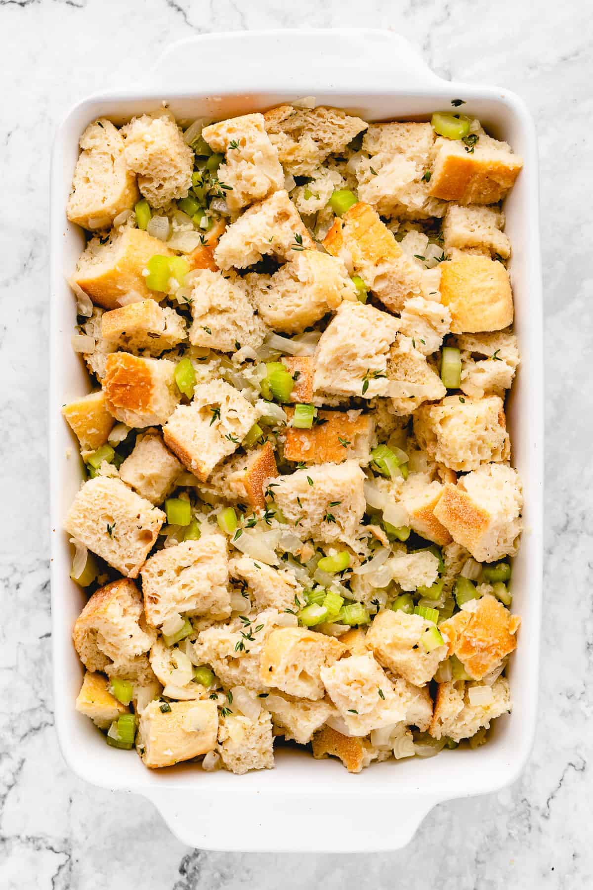 uncooked stuffing in casserole dish before cooking