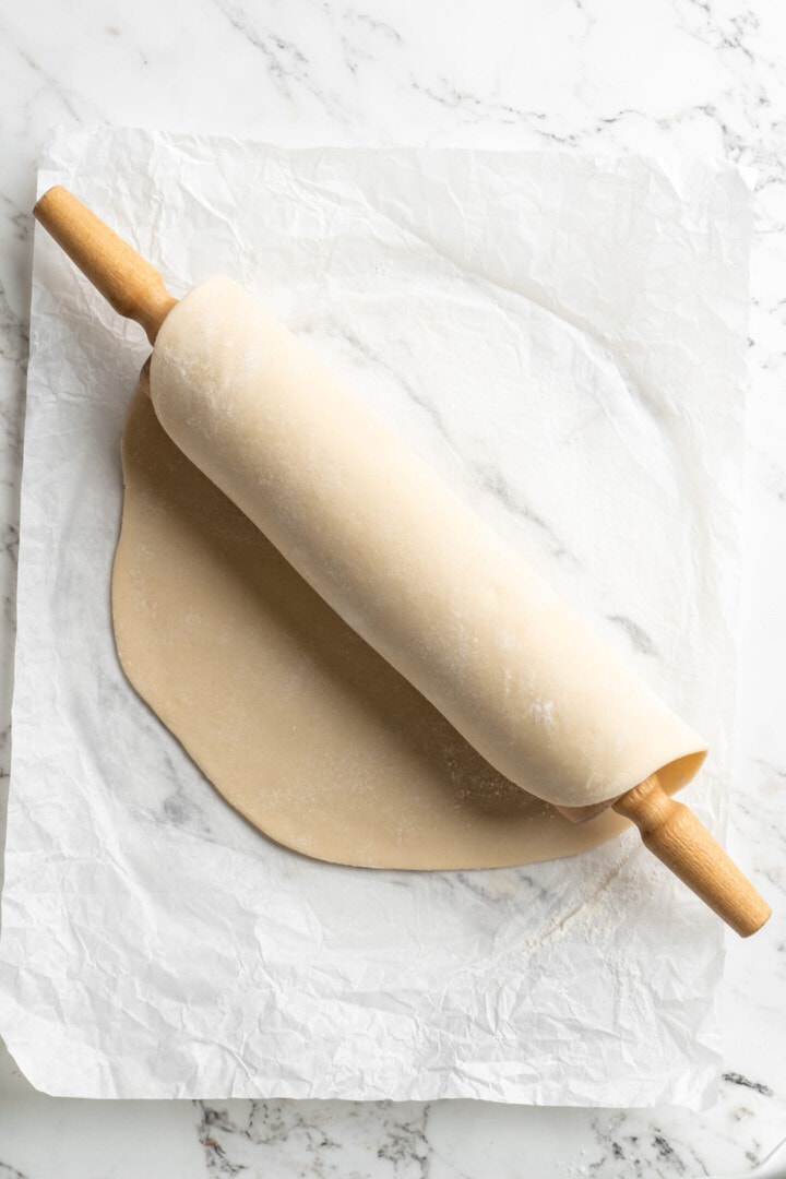 rolled out pie dough over rolling pie