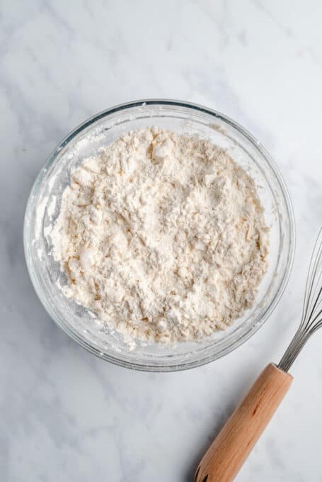 The Combined Dry Ingredients for Vegan Biscuits Inside a Glass Mixing Bowl