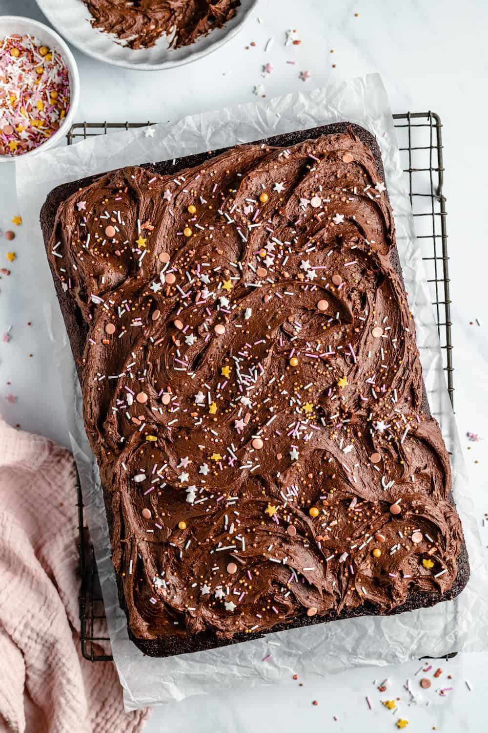 Chocolate sheet cake with chocolate frosting and sprinkles.