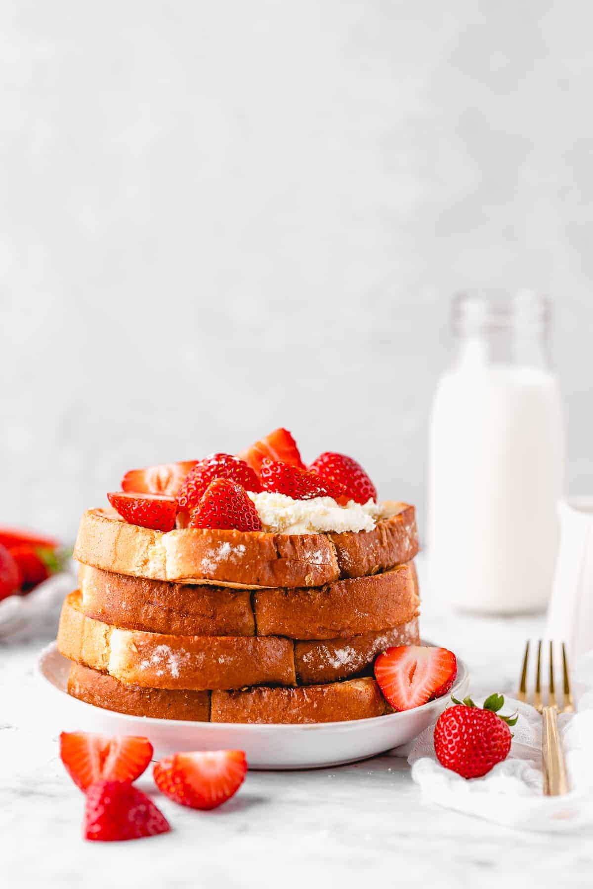 French toast with whipped cream and strawberries.