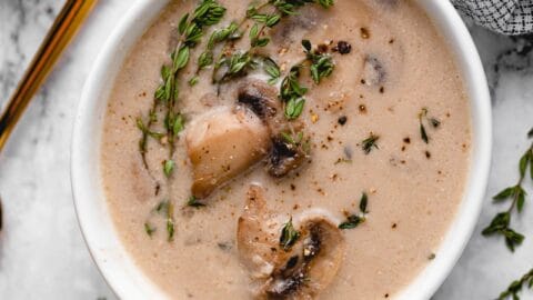 Overhead shot of mushroom soup with a gold spoon