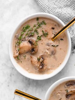 Overhead shot of mushroom soup with a gold spoon