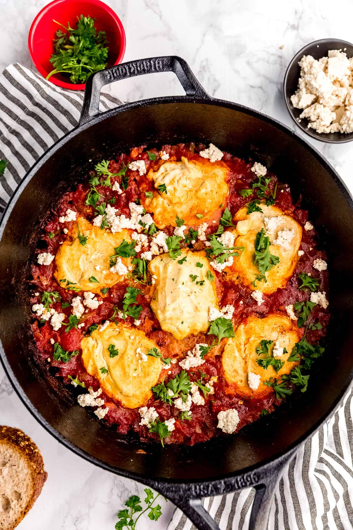 shakshuka in a cast iron skillet with parsley sprinkled over