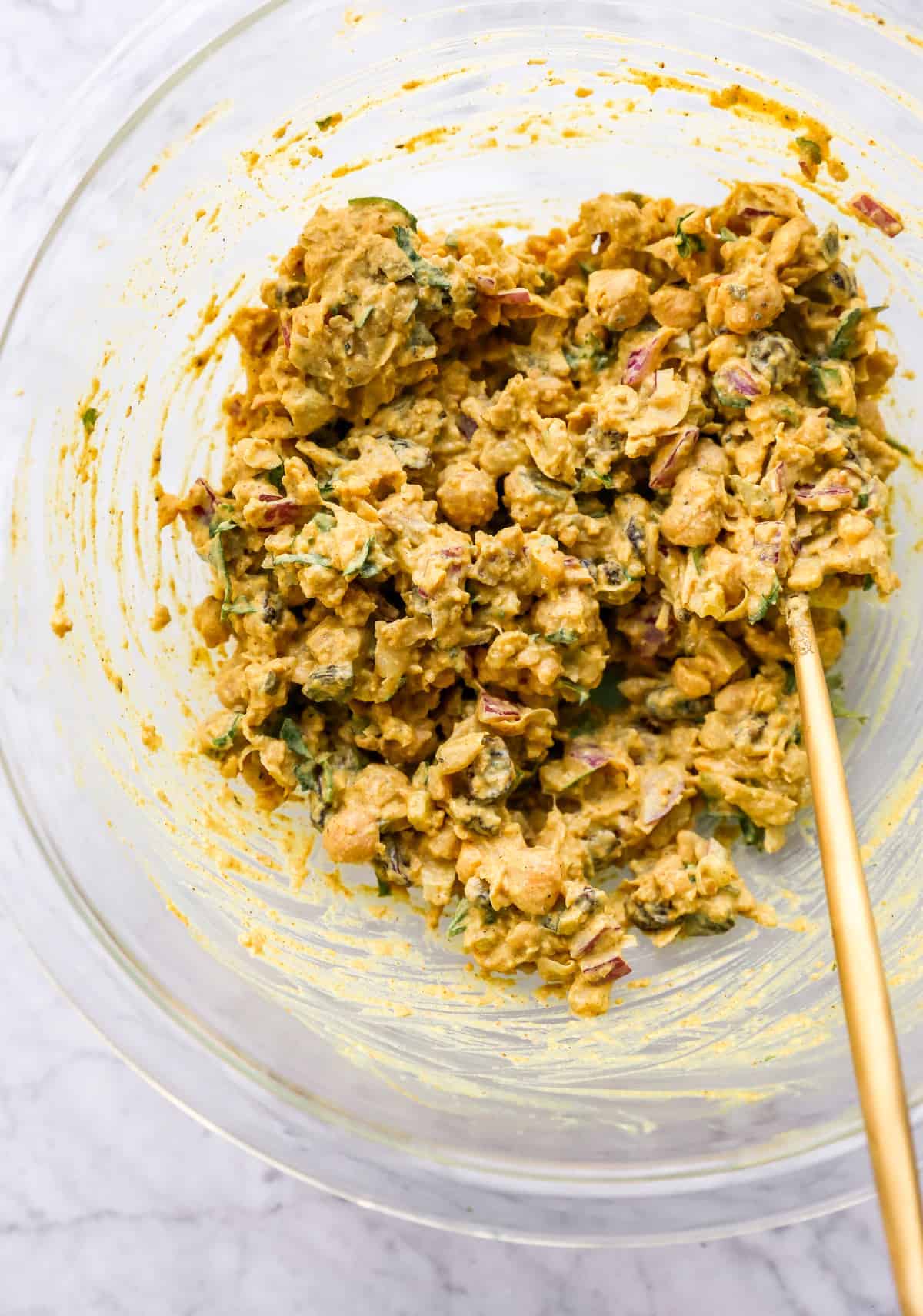 curried chickpea salad ingredients in a bowl