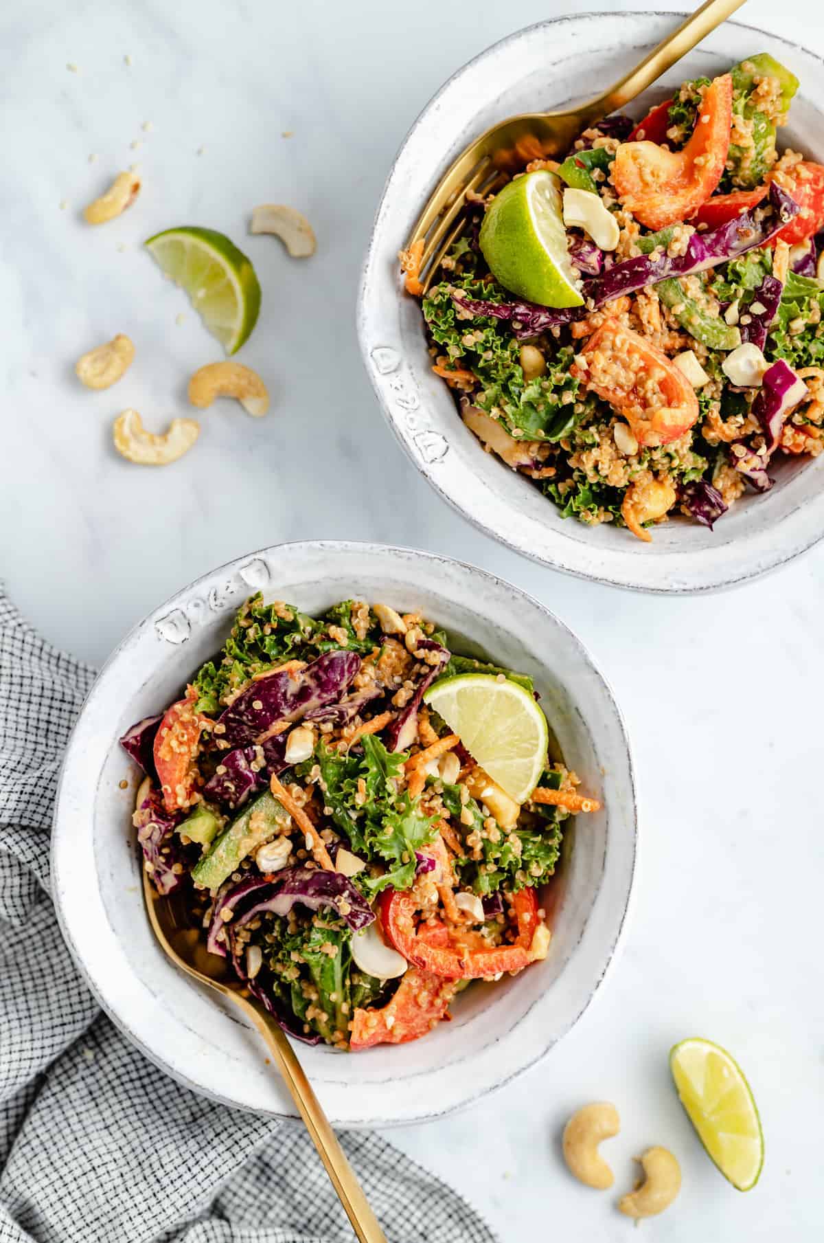cashew Thai quinoa salad shared out into two bowls with forks in them