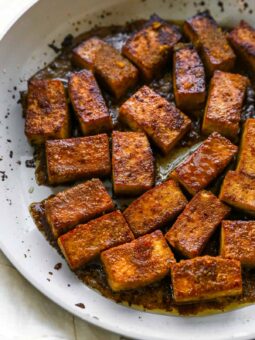 marinated and cooked tofu with leftover sauce in pan