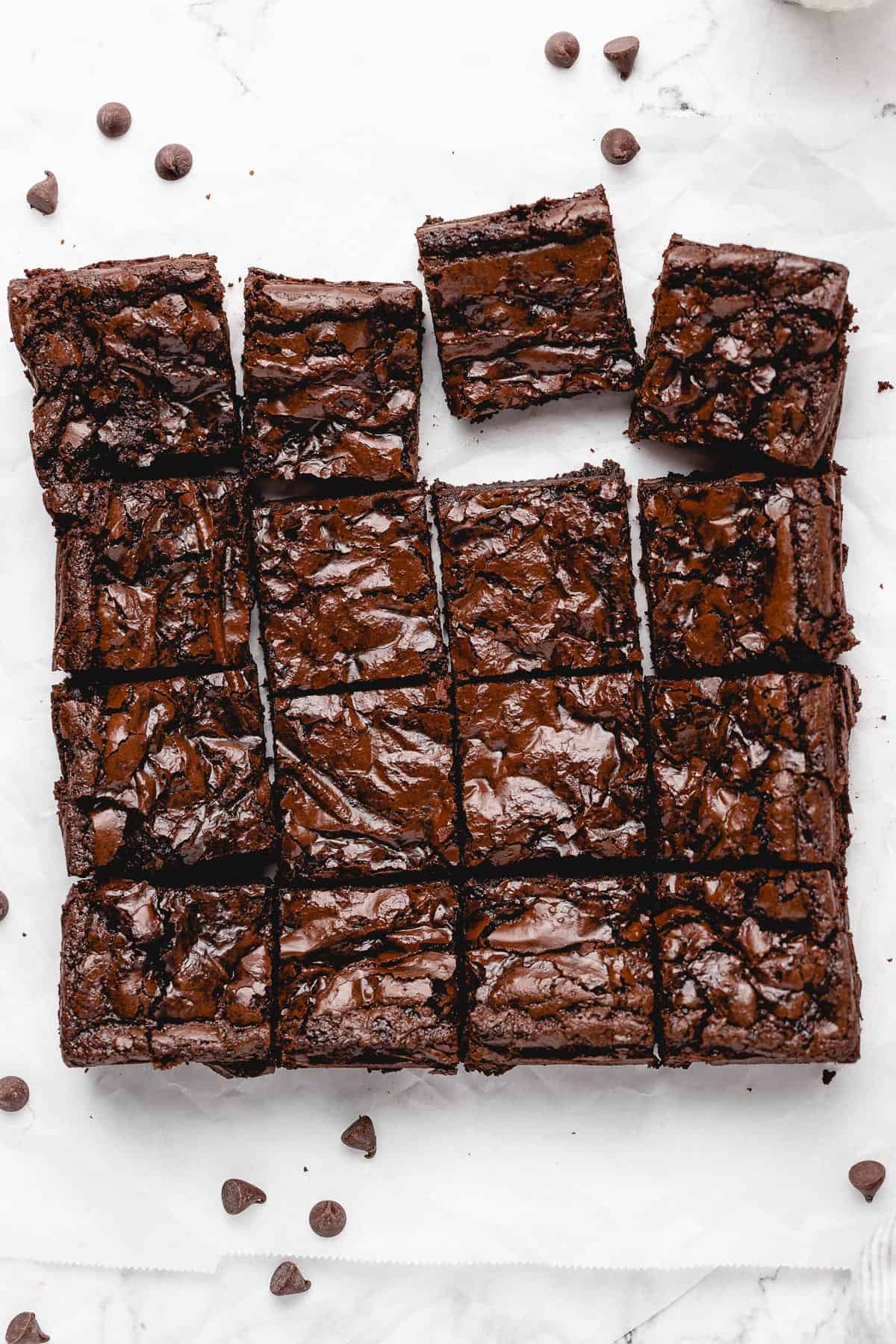 all 16 brownies sliced and a few pulled from the square, top down view