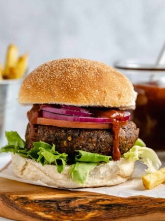 Black bean burger with onion and lettuce.
