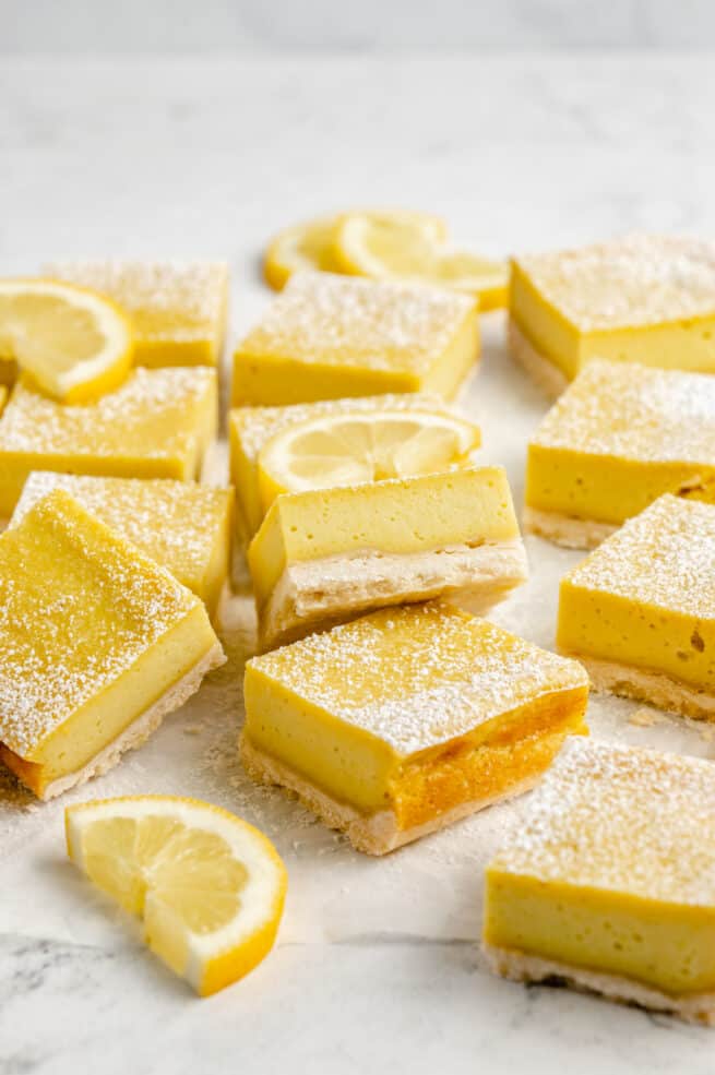 Sliced lemon bars with halved lemon slices.