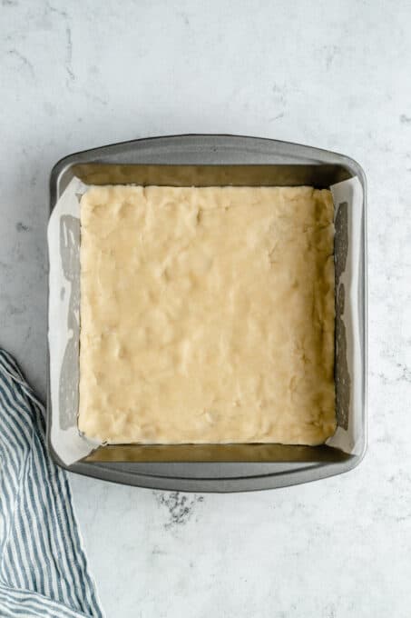 Pressed shortbread crust in a pan.
