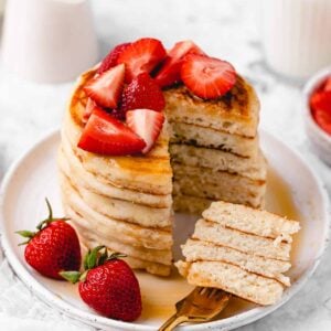 Sliced pancake stack with strawberries.