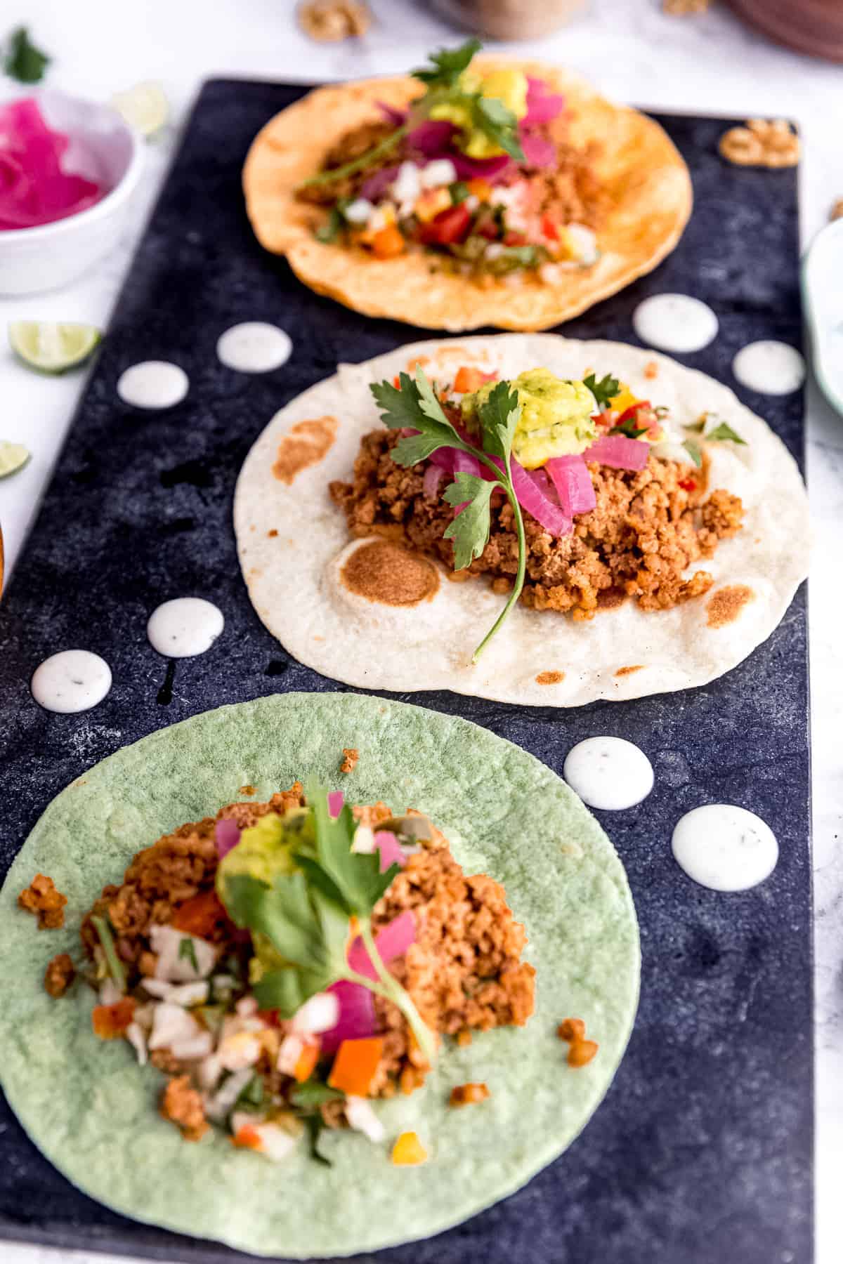 Vegan tacos with guacamole and pickled onions.