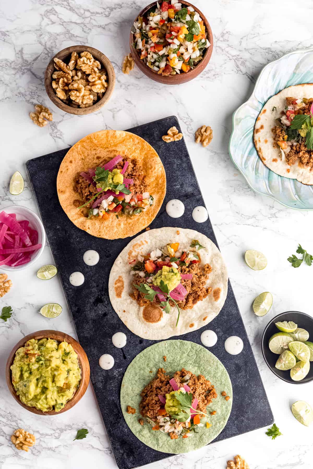 Ground walnut tacos with toppings.