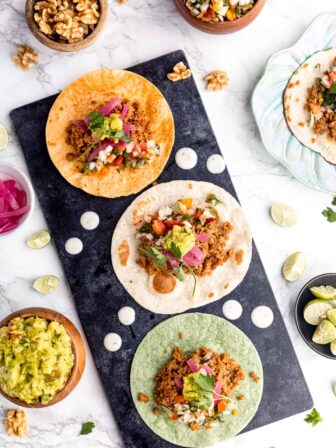 Three vegan tacos on a platter.