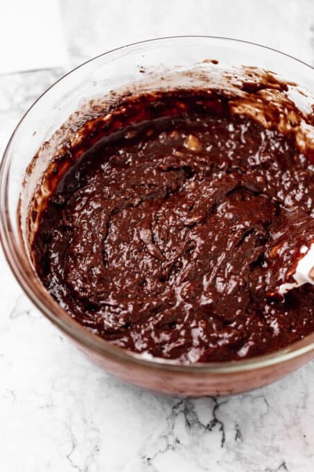Banana bread batter in a bowl with cocoa powder.