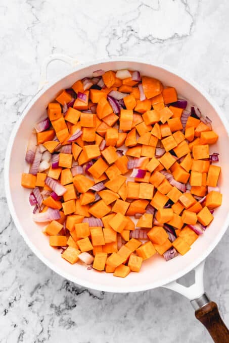 Sweet potato and onion in a pan.