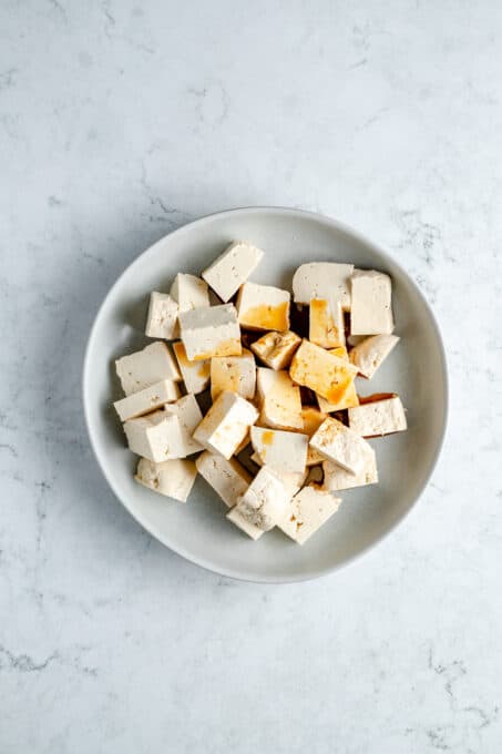 Plate of cubed tofu with soy sauce.