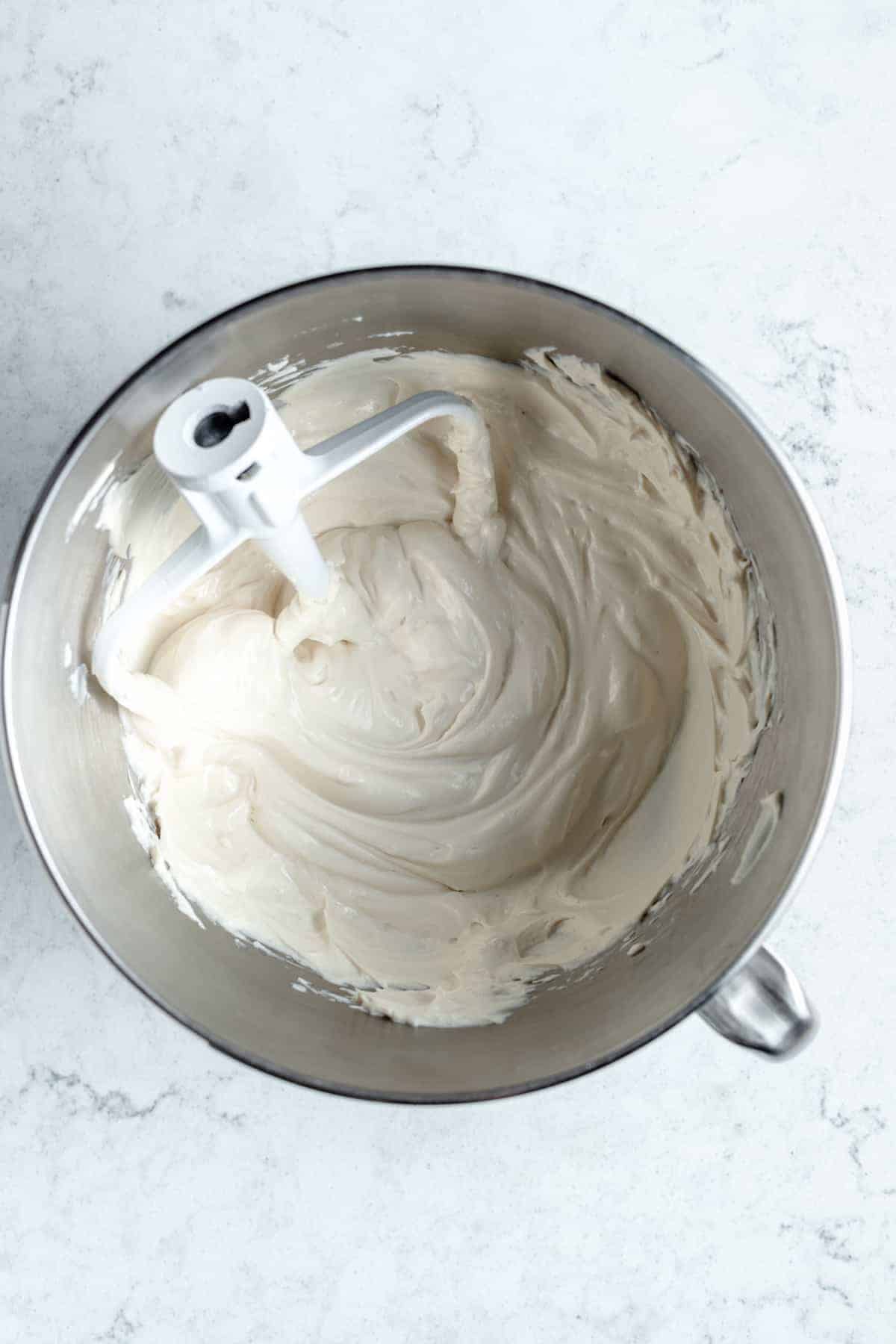 Beaten cream cheese in a mixing bowl.