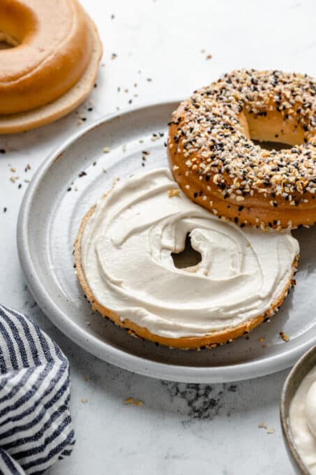 Smooth cream cheese spread on a bagel.