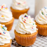 Vegan vanilla cupcakes with rainbow sprinkles.