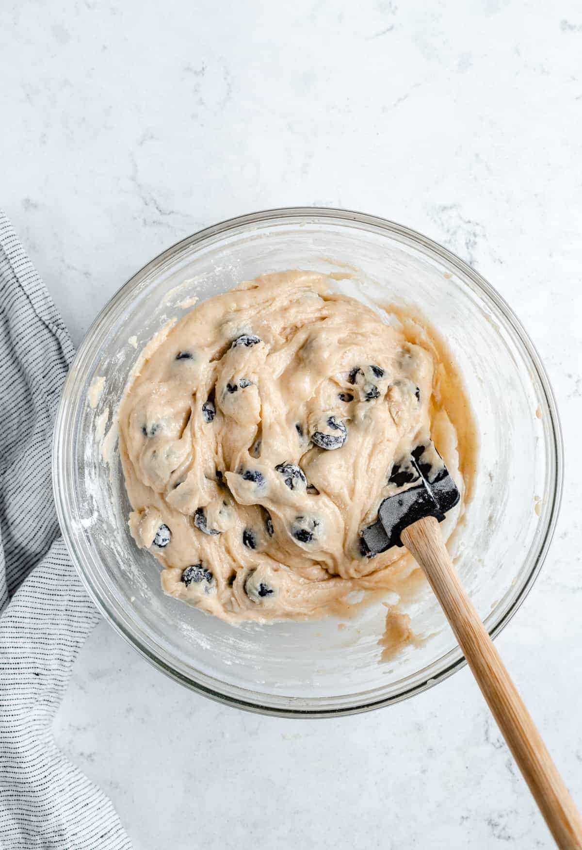 Blueberry muffin batter in a mixing bowl.